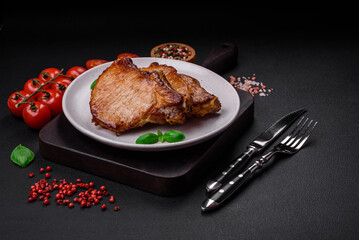 Delicious juicy pork or beef steak with salt, spices and herbs