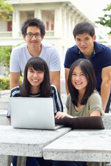 Smile, portrait and students with a laptop for education, studying and college research. Happy, Asian and men and women with a computer and notes for university work, learning and a group project