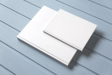 Two paper books with white covers without drawings. Mockup, copy space.