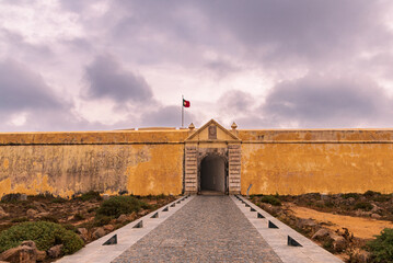 Walls and entrance gate to the fortress of Sagres in Portugal, on a cloudy day.
