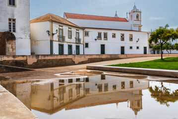 Fototapeta na wymiar Church of San Antonio in the city of Lagos, Portugal, side view and reflected in the rain water.