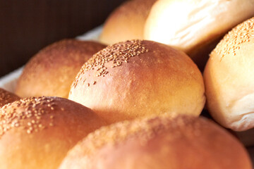 Sesame bread, food and bakery basket of rolls from cooking, catering service, breakfast or baking meal at cafe. Closeup of fresh baked, buns or roll snack for eating, nutrition or fiber in restaurant