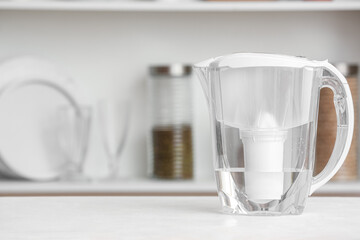 Water filter jug on table in kitchen