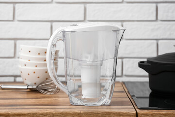Water filter jug on kitchen counter near white brick wall