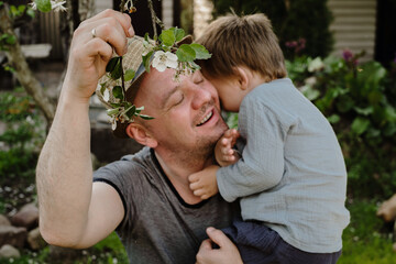 Father and little son enjoy spring spend time together outdoors. Family affection concept.