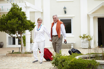 Travel, hotel and happy senior couple walking with suitcase in a holiday or vacation location in...