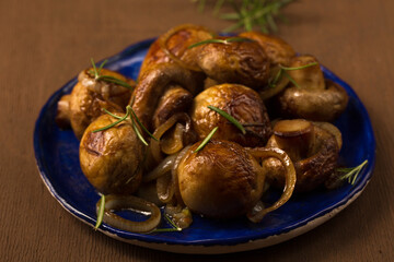 Fried mushrooms champignons with onions on a plate