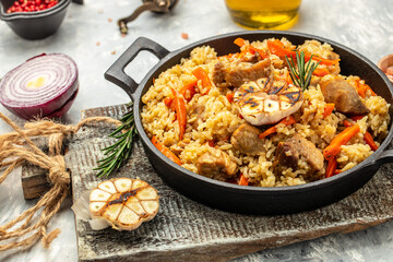 Uzbek food pilaf in cast-iron pan. banner, menu, recipe place for text