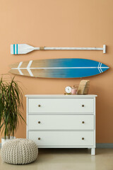 Interior of room with surfboard, paddle and commode