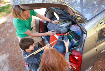 Happy family, road trip and packing car above for camping, holiday or vacation together in nature...