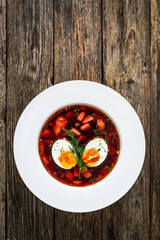 Red borsch - beetroots soup on wooden table