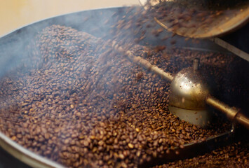 Cafe, mix and coffee beans in a machine for a raw blend, textures and steam in a pot. Food,...