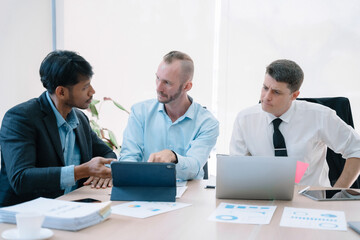 Obraz premium Group of diverse business people discussing a project in a meeting for analysis graph company financial.