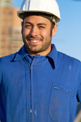 Happy man, architect and portrait smile for construction, building or industrial architecture in the city. Male person, engineer or contractor smiling with hard hat for safety in maintenance on site