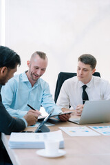Fototapeta premium Group of diverse business people discussing a project in a meeting for analysis graph company financial.
