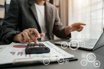 accountant working on laptop computer with business document, graph diagram and calculator on...