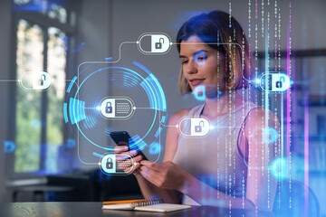 Smiling businesswoman in casual wear holding using smartphone typing at office workplace with notebook. Concept of distant work, business education. Blockchain crypto hologram