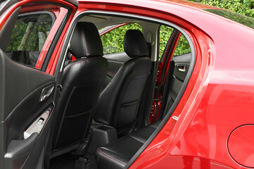 Obraz na płótnie Canvas The rear passenger seat is wide and clean. Leather interior, side view, solar sunroof, buttons, Nappa leather, beige,black
