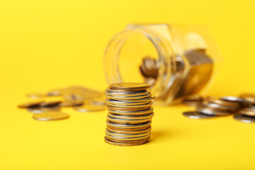 Stack of coins on yellow background