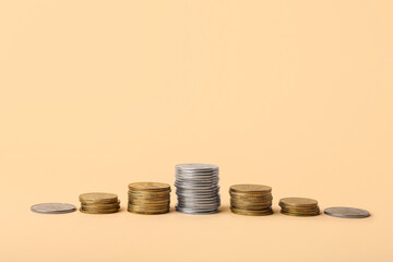 Stacks of coins on beige background
