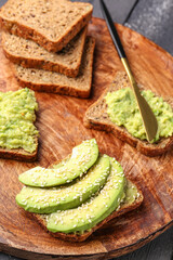 Plate of tasty avocado toasts on table, closeup