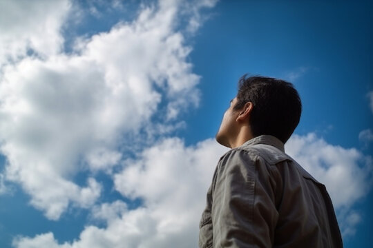 unrecognizable Man feeling free looking up to the sky