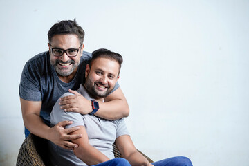 Two young indian man giving expression on white background.