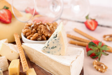 Different types of tasty cheese on table, closeup