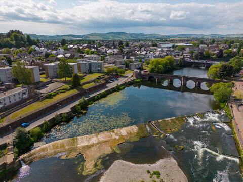 This aerial drone photo shows the town of Dumfries in the district of Dumfries and Galloway in Scotland. You can see the river Nith which flows through the center of the town. 