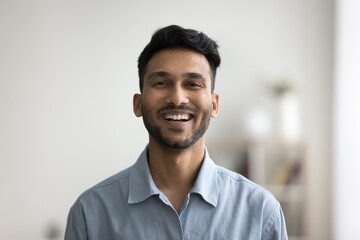 Happy handsome young Indian man head shot front portrait. Cheerful successful entrepreneur, startup...