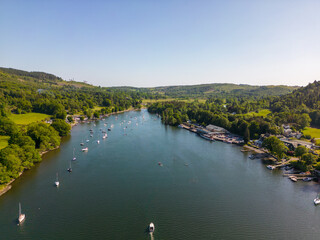 Fototapeta premium This aerial drone photo shows Lake Windermere which is the largest lake in the Lake District. This beautiful nature can be found in Cumbria, North-West England. It's summer and there are many boats. 