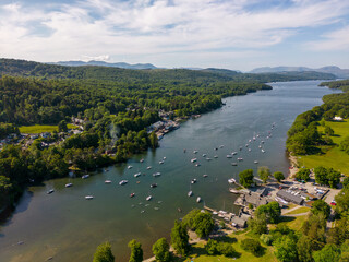 Obraz premium This aerial drone photo shows Lake Windermere which is the largest lake in the Lake District. This beautiful nature can be found in Cumbria, North-West England. It's summer and there are many boats. 
