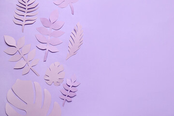 Fototapeta na wymiar Different paper tropical leaves on lilac background