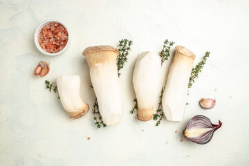 Group of the fresh cultivated Eringi mushrooms, king oyster mushroom on a light background, banner, menu, recipe place for text, top view