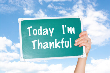 A sign with a raised hand reads "Today I'm Thankful"
