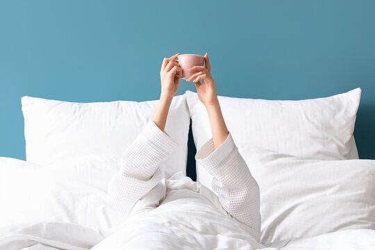 Morning Of Young Woman With Cup Of Coffee In Bed