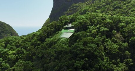 Hang gliding take off from the ramp on high mountain in Rio de Janeiro. Aerial view