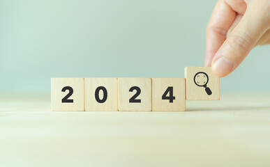 2024 trend and seeking new opportunities concept. Wooden cube with 2024, magnifying glass icon. Used for banner in trend concept in new year for monitoring new opportunities, process improvement.