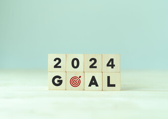 2024 goals of business or life. Wooden cubes with 2024 and goal icon on smart background. Starting to new year. Business common goals for planning new project, annual plan, business target achievement