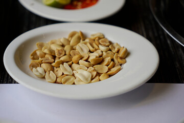 Roasted peanuts on a plate served as side dish or appetizer