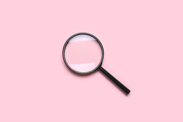 Black magnifier on pink background
