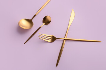 Stylish cutlery on pink background