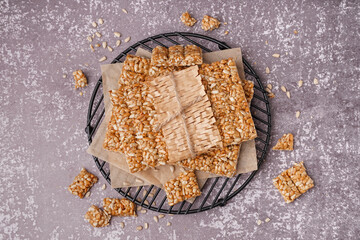 Stand with tasty kozinaki on grunge grey background