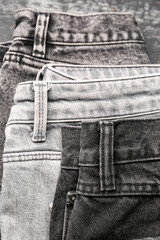 Different stylish denim jeans, closeup