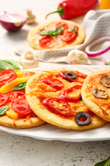 Plate with different tasty mini pizzas, closeup