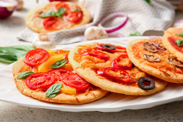 Plate with different tasty mini pizzas, closeup