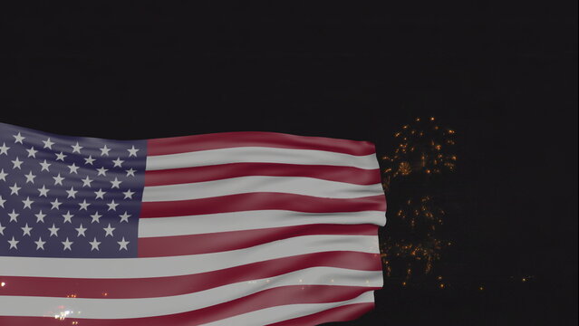United States national flag waving with night fireworks on the background