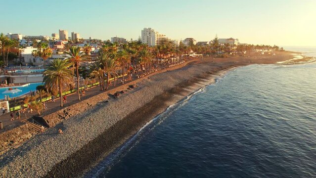 Aerial view of Playa de las Americas beach at sunset, Tenerife, Spain. 