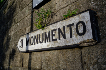 Iconic portuguese signboard with word "MONUMENTO" (Monument) in Vila Nova de Gaia, Portugal - 2023.