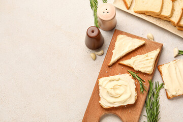 Wooden board of tasty toasts with cream cheese on light background
